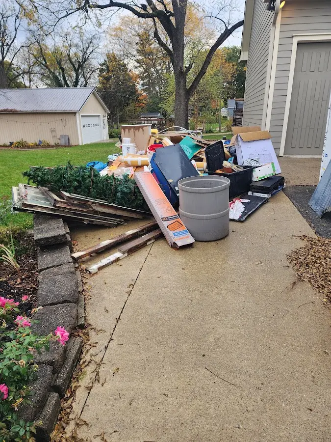Dumpster being loaded with debris for 10 Yard Dumpster Rental in Cumberland